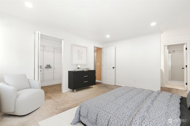 carpeted bedroom with a closet, crown molding, and a walk in closet