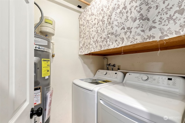 laundry area with washing machine and clothes dryer and secured water heater