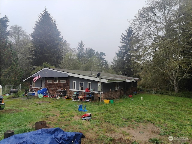 rear view of house featuring a lawn
