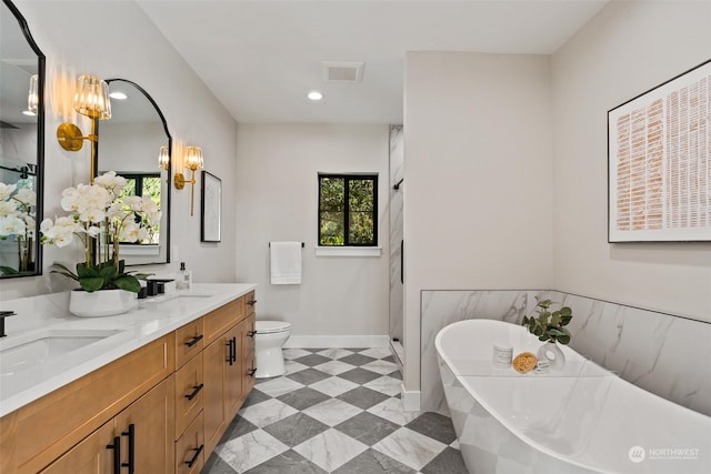 bathroom with a bath, toilet, and vanity