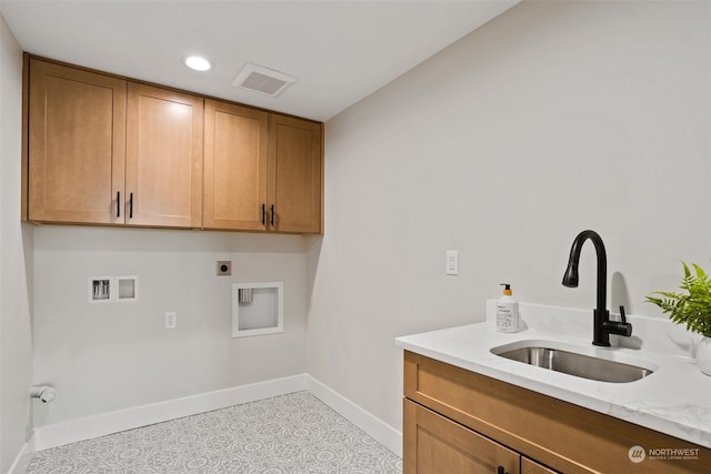 washroom featuring electric dryer hookup, washer hookup, sink, and cabinets