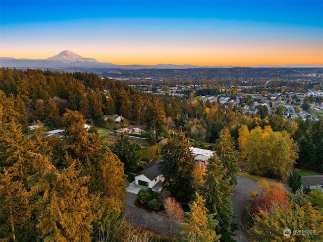 aerial view at dusk featuring a mountain view