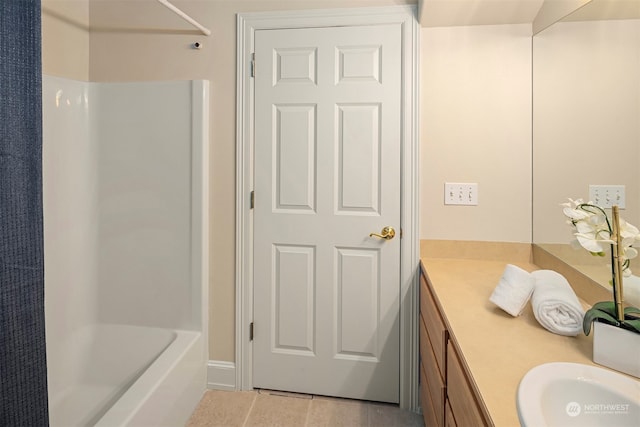 bathroom with tile patterned flooring, bathing tub / shower combination, and vanity