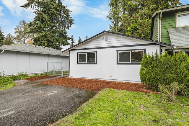 view of side of home featuring a yard