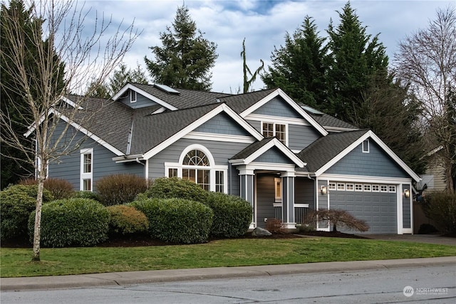 view of front of house with a garage and a front lawn