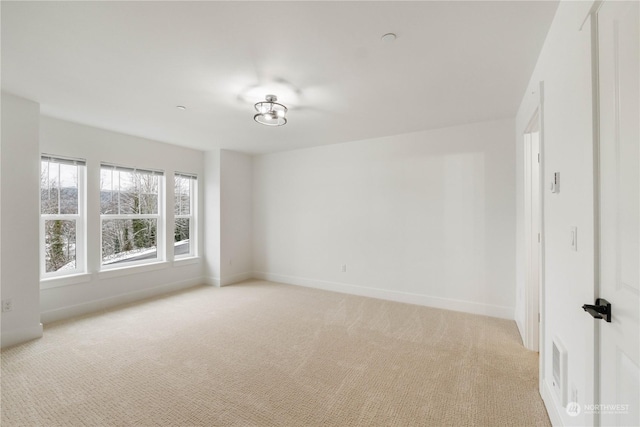 spare room with light colored carpet