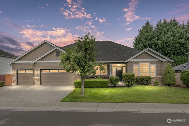 view of front facade with a garage and a lawn