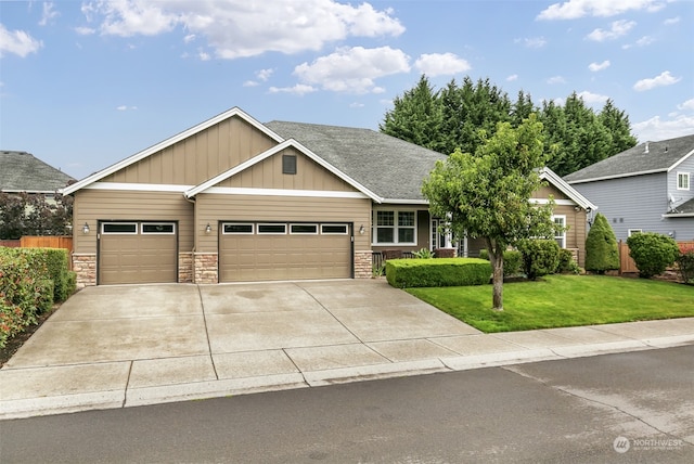 view of front of house featuring a garage and a front lawn