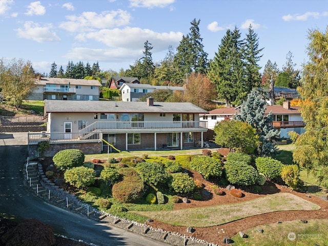 rear view of house featuring a wooden deck