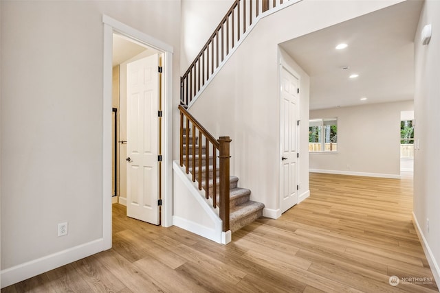 stairway with hardwood / wood-style flooring