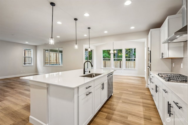 kitchen featuring white cabinetry, a kitchen island with sink, sink, and stainless steel appliances