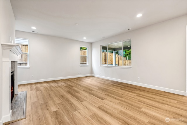 unfurnished living room featuring light wood-type flooring