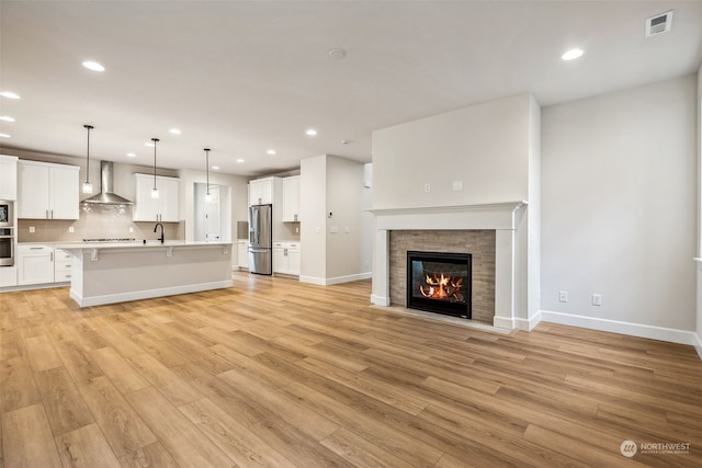 unfurnished living room with light wood-type flooring