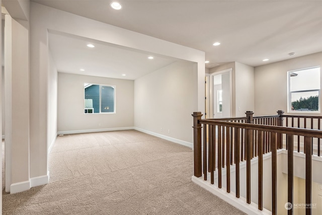 hall featuring light colored carpet