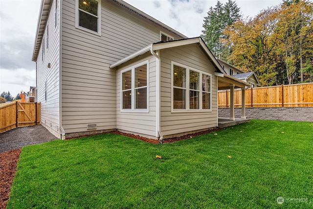 rear view of property featuring a yard