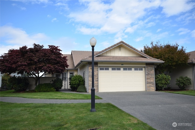 ranch-style house featuring a front yard and a garage