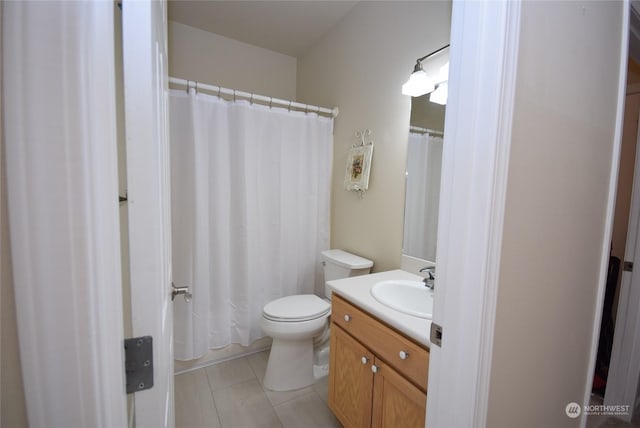 full bathroom with vanity, tile patterned flooring, and toilet