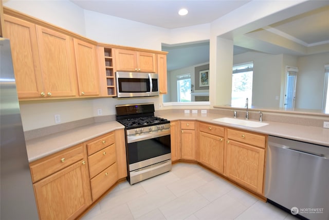 kitchen with light brown cabinetry, appliances with stainless steel finishes, and sink