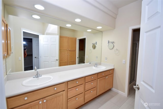 bathroom with vanity, walk in shower, and tile patterned flooring