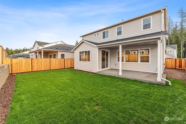 rear view of property with a lawn and a patio area