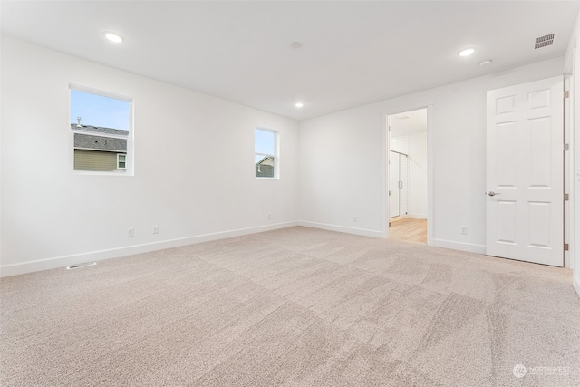 spare room with light colored carpet