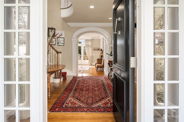 hall with crown molding and hardwood / wood-style flooring