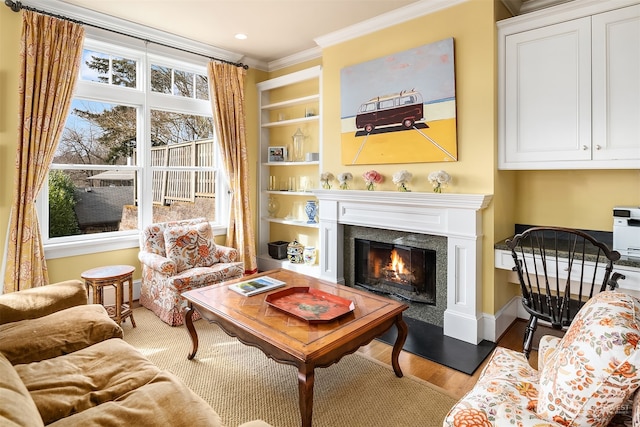 living area with crown molding and hardwood / wood-style floors