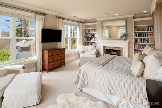 bedroom with crown molding, carpet flooring, and multiple windows