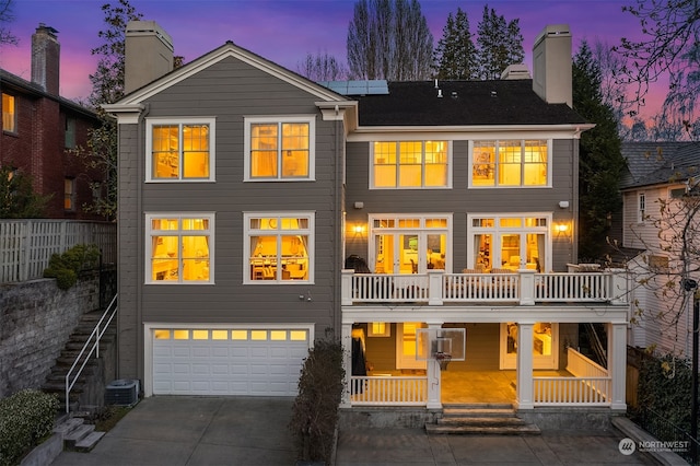 back house at dusk with a garage