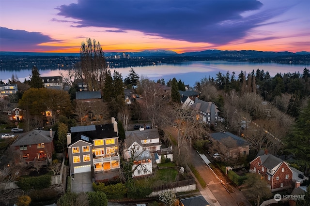 aerial view at dusk with a water view