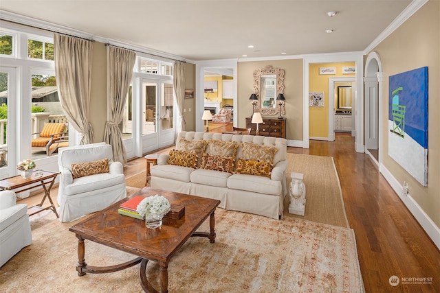 living room with ornamental molding and light hardwood / wood-style floors