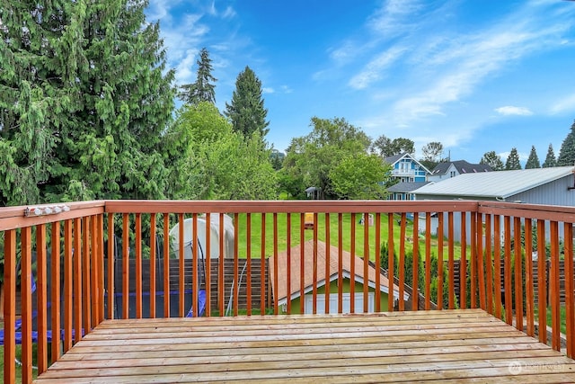 wooden deck with a lawn