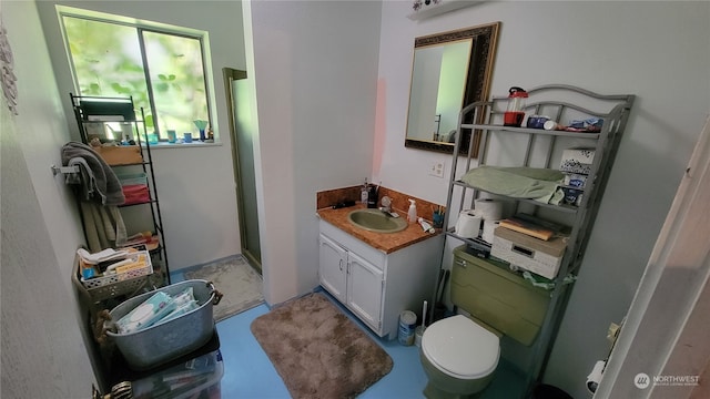 bathroom featuring a shower, vanity, and toilet