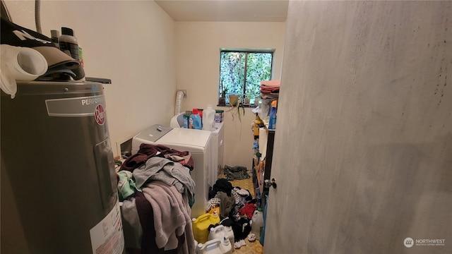 clothes washing area featuring water heater and independent washer and dryer