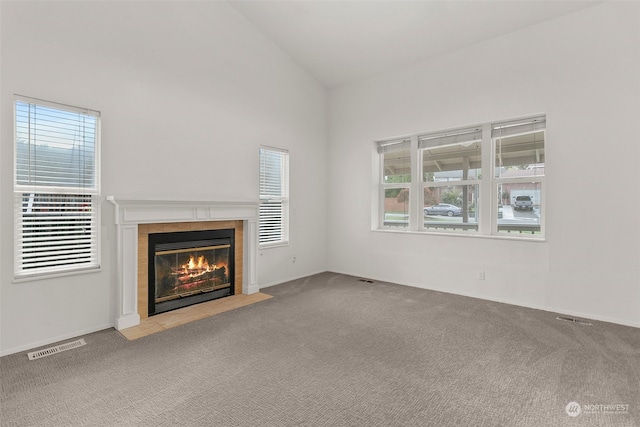 unfurnished living room with a fireplace, carpet flooring, and vaulted ceiling