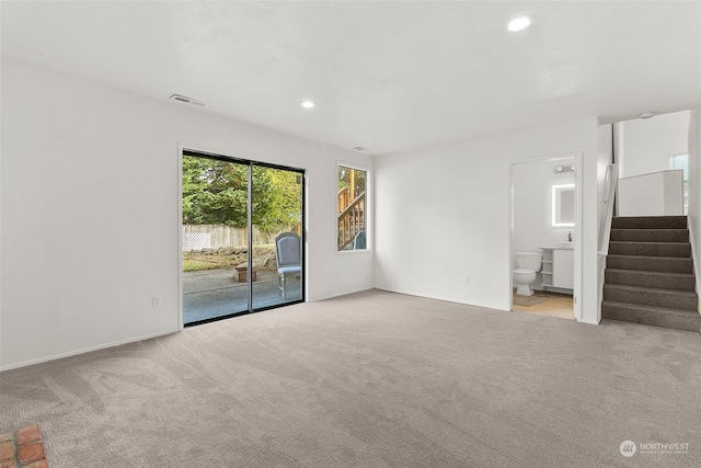 unfurnished living room with light carpet