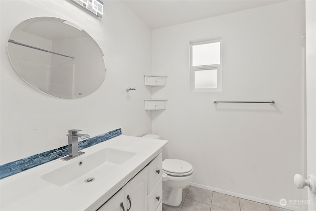 bathroom featuring vanity, a shower, toilet, and tile patterned floors