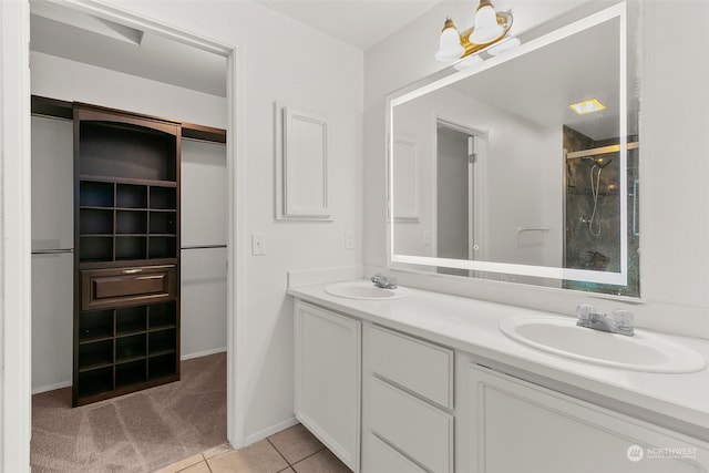 bathroom with tile patterned floors, vanity, and walk in shower