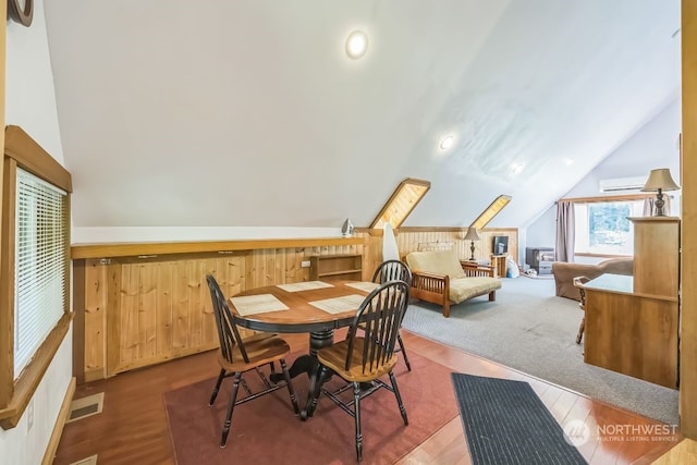 dining area with lofted ceiling and hardwood / wood-style floors