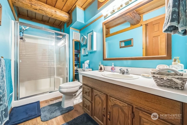 bathroom featuring hardwood / wood-style floors, toilet, wooden ceiling, walk in shower, and vanity