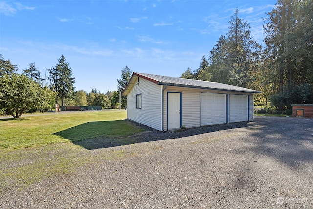 garage featuring a lawn