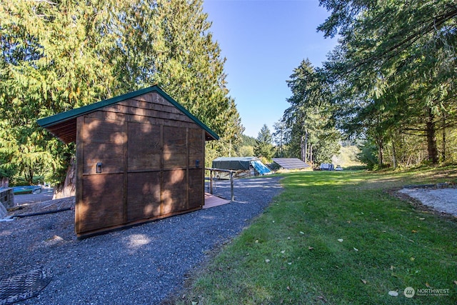 view of outdoor structure featuring a lawn