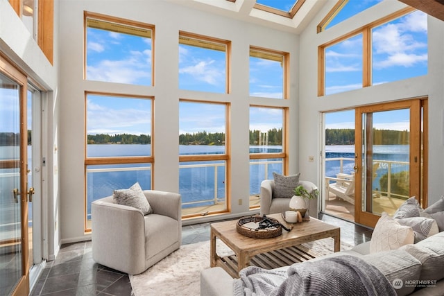 2210E Mason Lake Dr W, Grapeview, WA 98546 - sunroom featuring a water view, a towering ceiling, and a skylight
