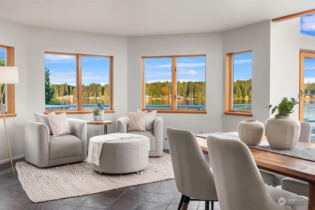 2210E Mason Lake Dr W, Grapeview, WA 98546 - living area featuring healthy amount of natural light, dark stone finish floors, and baseboards
