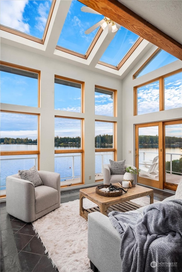 2210E Mason Lake Dr W, Grapeview, WA 98546 - living room with a water view, a skylight, a ceiling fan, beam ceiling, and high vaulted ceiling