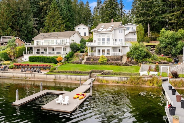 2210E Mason Lake Dr W, Grapeview, WA 98546 - dock area with a water view, a balcony, and a lawn