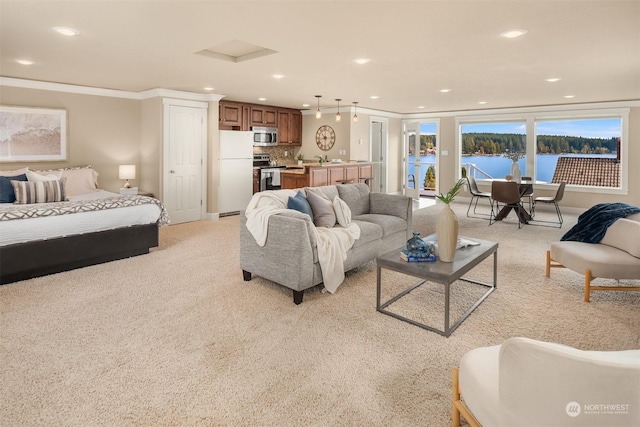 2210E Mason Lake Dr W, Grapeview, WA 98546 - living room featuring recessed lighting, light colored carpet, ornamental molding, a water view, and baseboards