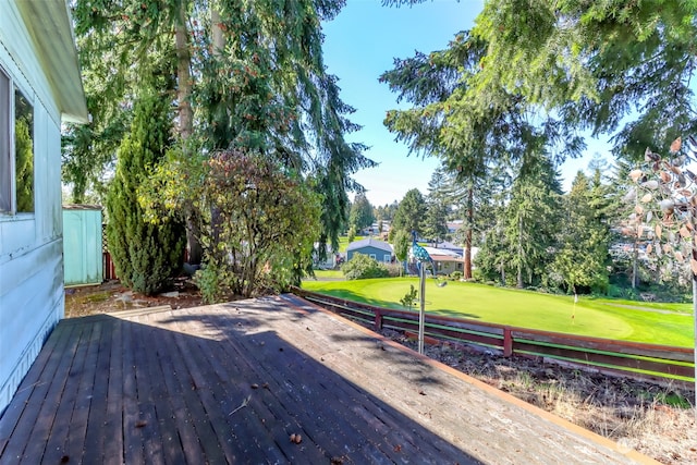 wooden terrace with a lawn