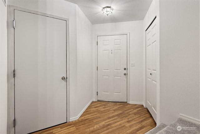 entryway featuring light wood-style floors and baseboards