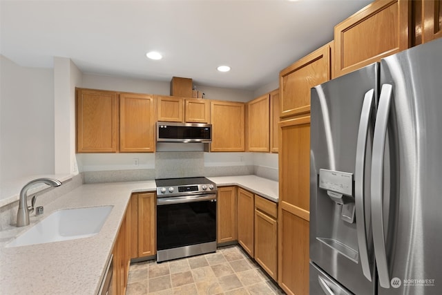 kitchen featuring a sink, appliances with stainless steel finishes, and recessed lighting